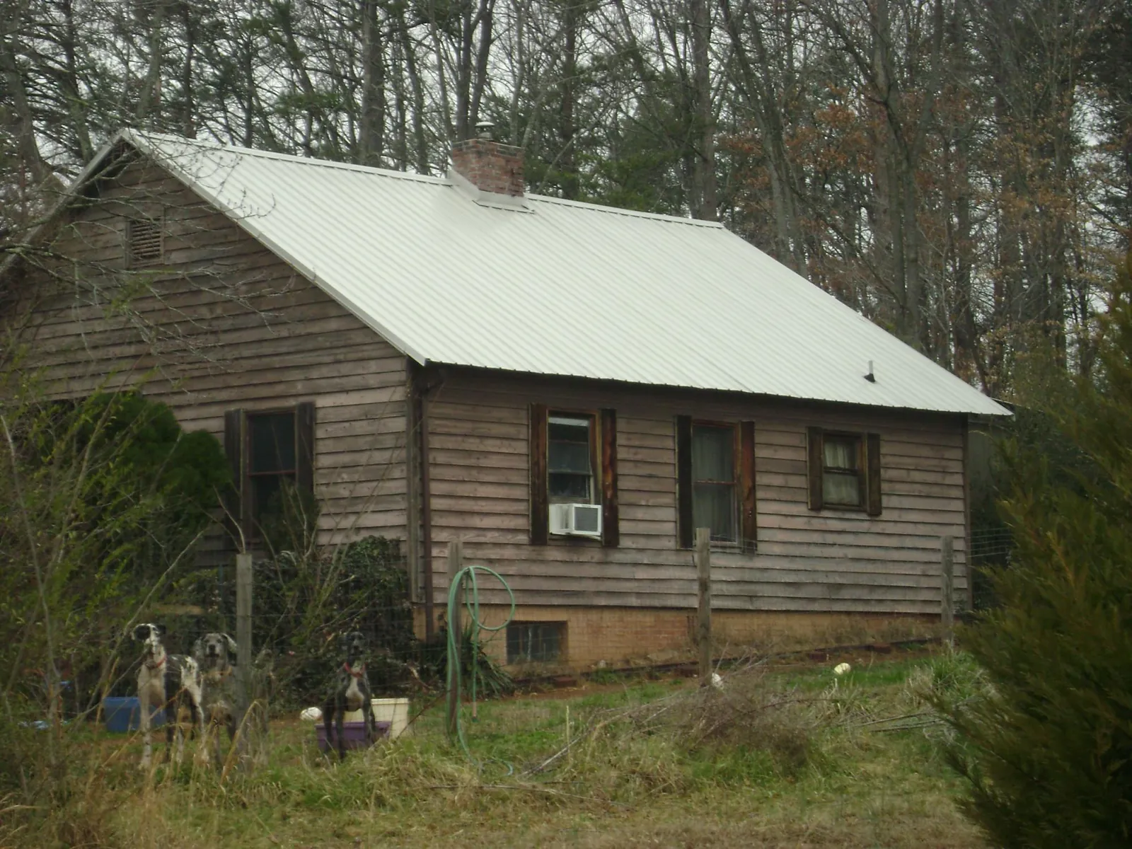 White metal roof on an old wood sided farmhouse, from a Metal Roof Installation job in Camden